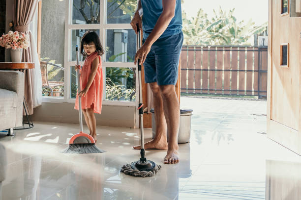 istock father and daughter clean up the house 1149970025