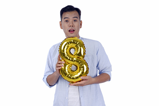 Asian handsome young man with party gold foil balloon