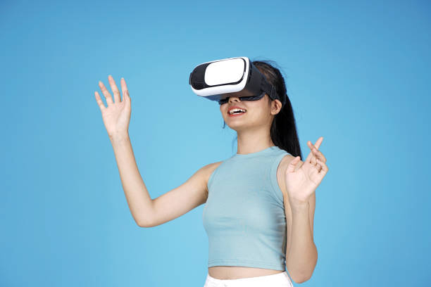 istock Asian young attractive beautiful young female student with 3D VR device on blue background 1149999621