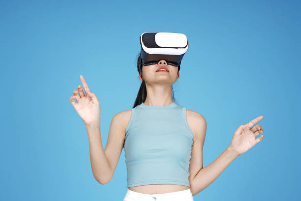 istock Asian young attractive beautiful young female student with 3D VR device on blue background 1149999630