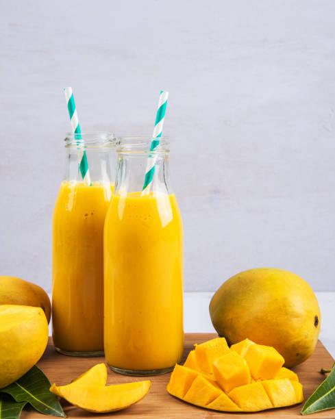 istock Mango Smoothie In A Bottle With Slices Of Mango Fruit And Leaf 1150000164