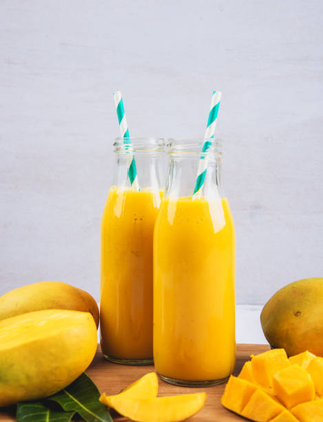 istock Mango Smoothie In A Bottle With Slices Of Mango Fruit And Leaf 1150000168