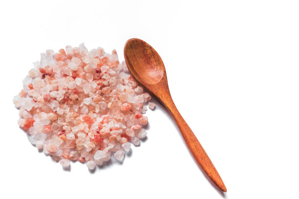 istock Pink salt from Bolivian and spoon isolated on white background 1150006012