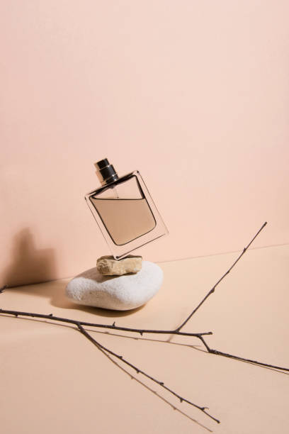 Pastel color perfume falling from the a stone . Abstract still life. Makeup collection 5.