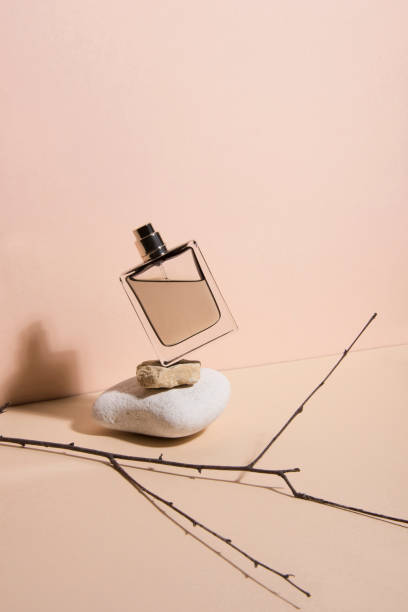 Pastel color perfume falling from the a stone . Abstract still life. Makeup collection 5. stock photo