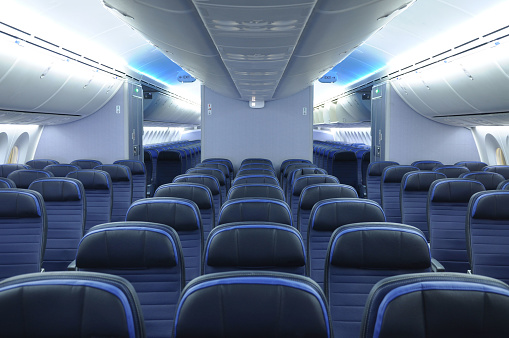 787 dreamliner commercial airplane cabin interior with blue leather seats