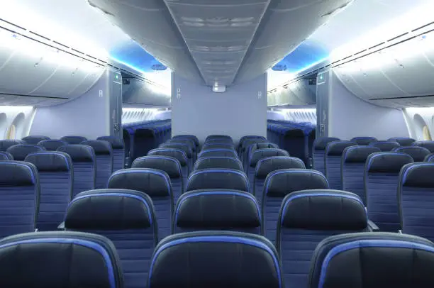 Photo of 787 dreamliner commercial airplane cabin interior with blue leather seats