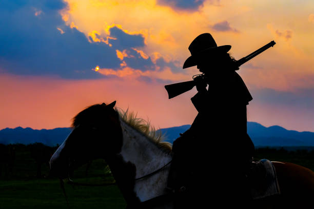 istock Cowboy silhouette on a horse during nice sunset 1150013757