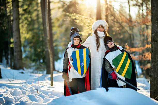 istock Thee kids playing winter queen and her knights 1150014715