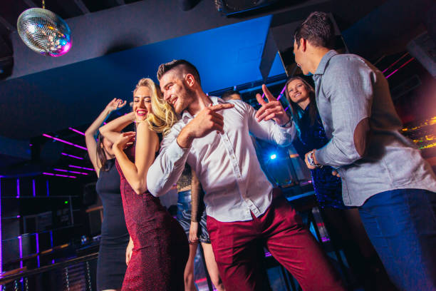 istock Young people dancing in night club 1150016406