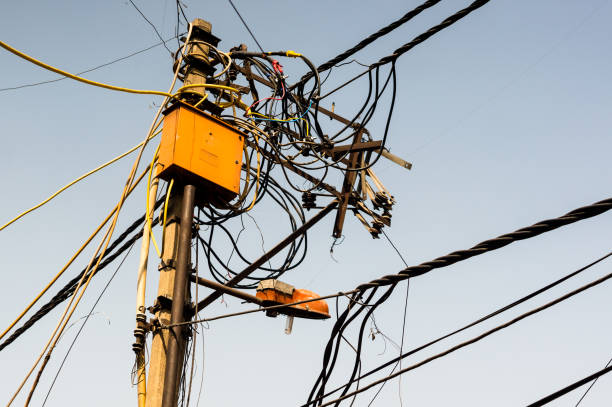 istock Tangled messy electrical wires on pole posing a safety hazard 1150016425