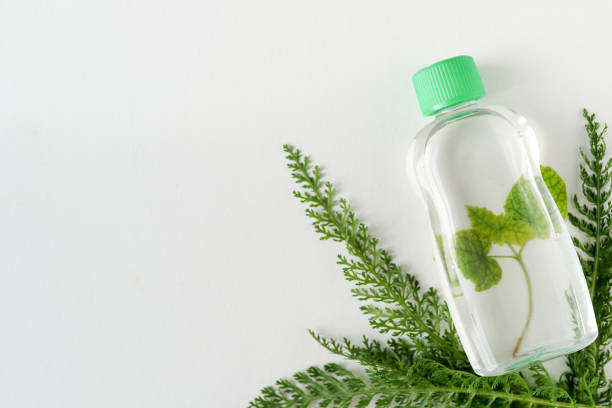 istock tonic or micellar cleansing water with fresh herbs on white background with copy space, top view. Beauty, skin, hair or body care concept 1150018793