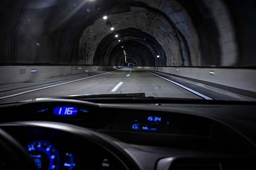 Driver view inside a car driving on a tunnel highway