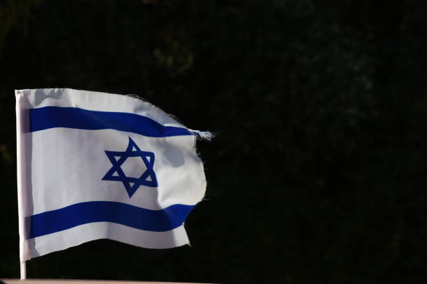 istock An Israeli flag on a black background 1150019744