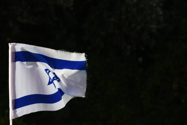 istock An Israeli flag on a black background 1150019747