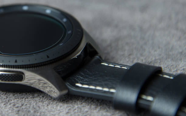 istock Digital watch face from above on a soft grey leather background 1150019822