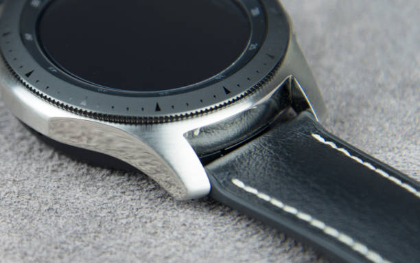 istock Digital watch face from above on a soft grey leather background 1150019826