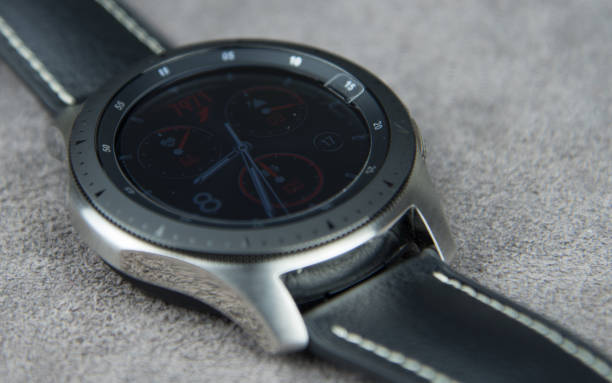 istock Digital watch face from above on a soft grey leather background 1150019830