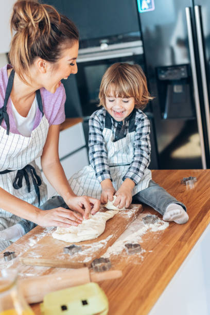 istock Mother and son making cookies 1150021081