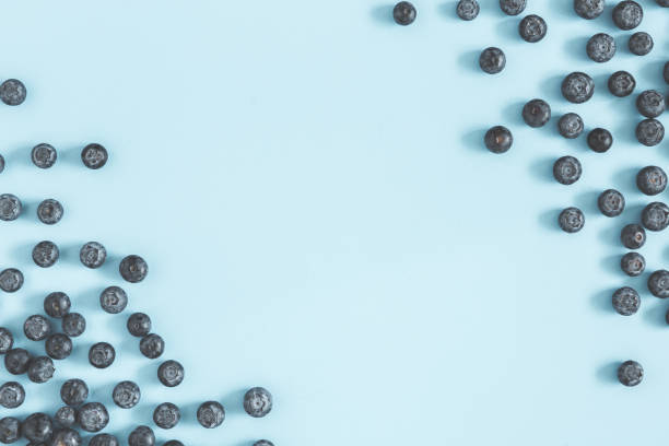 Blueberry on blue background. Flat lay, top view