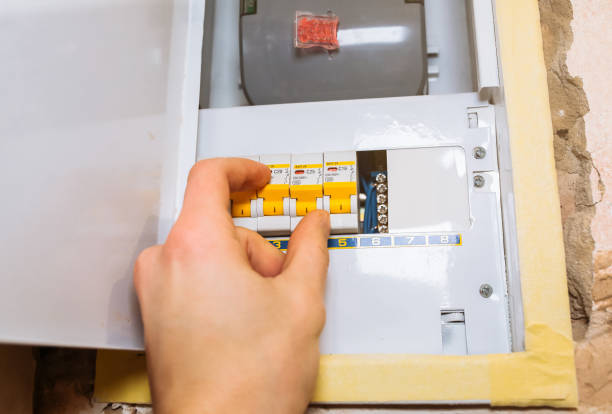 istock Worker is pressing switch on electrical panel. Maintenance repair works renovation in the flat. Restoration indoors. 1150022713