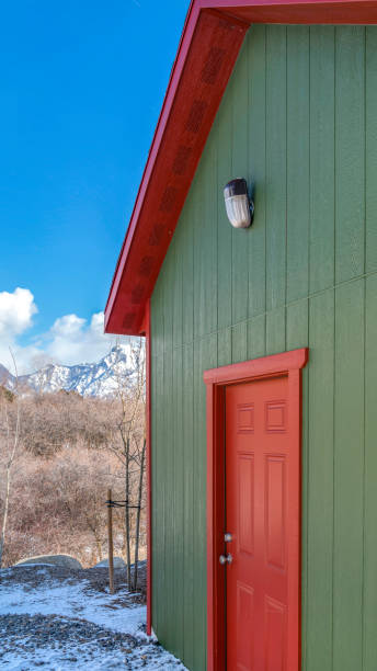 istock Clear Vertical Storage shed against trees and snow capped mountain under cloudy blue sky 1150024479