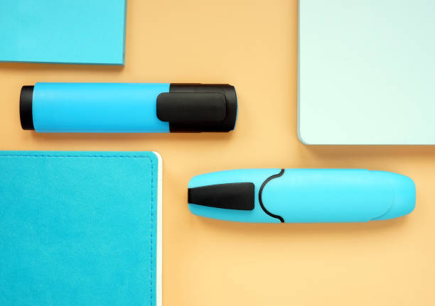 istock Blue notepads and markers on an orange surface. Top view flat lay of office supply. 1150025749