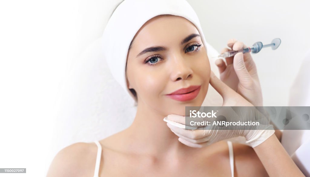 Beautician doctor cosmetologist at work. Biorevitalization cosmetology injection. Face skin treatment hyaluronic acid. Beauty facial filling. Filler. Botox procedure. Healthcare beauty concept Adult Stock Photo