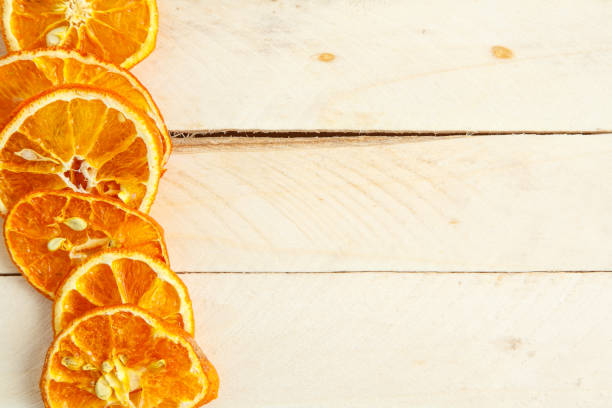 istock dried oranges on wooden background. top view 1150033967