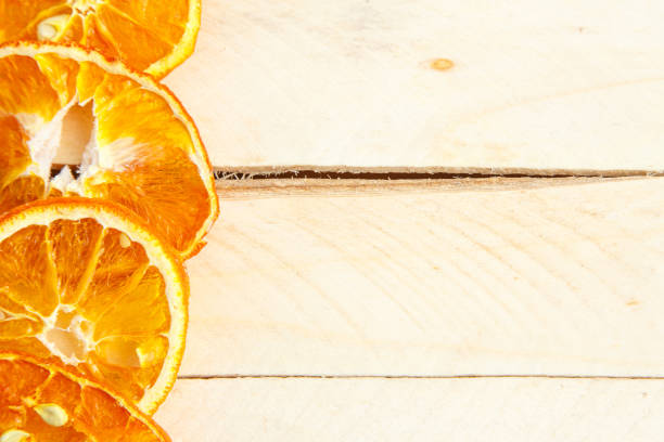 istock dried oranges on wooden background. top view 1150033971