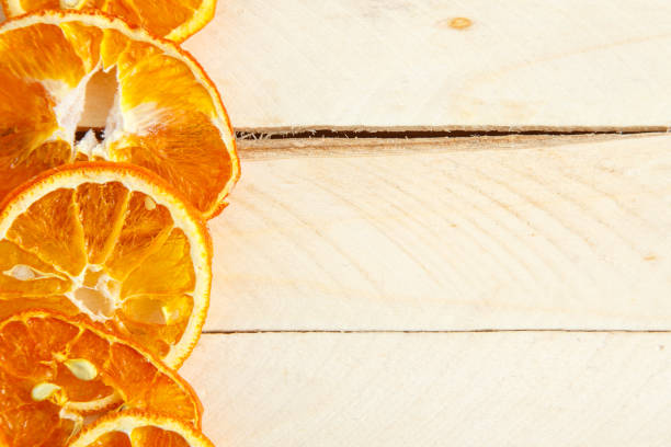 istock dried oranges on wooden background. top view 1150034034