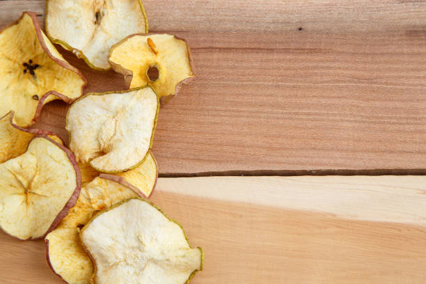 istock dried apples on wooden background. top view 1150034045