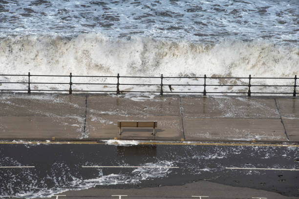 a metal bench looking out towards a rough sea