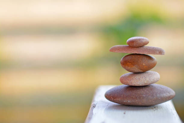 istock Balance zen stones put on white table with brown background left space position. 1150043293