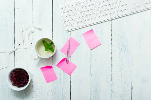 Mint tea, pink post its on office table work place with cup of mint tea, pink post its, and succulent plant, top view white shabby chic desk stock pictures, royalty-free photos & images