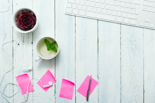 Mint tea, pink post its on office table work place with cup of mint tea, pink post its, and succulent plant, top view white shabby chic desk stock pictures, royalty-free photos & images
