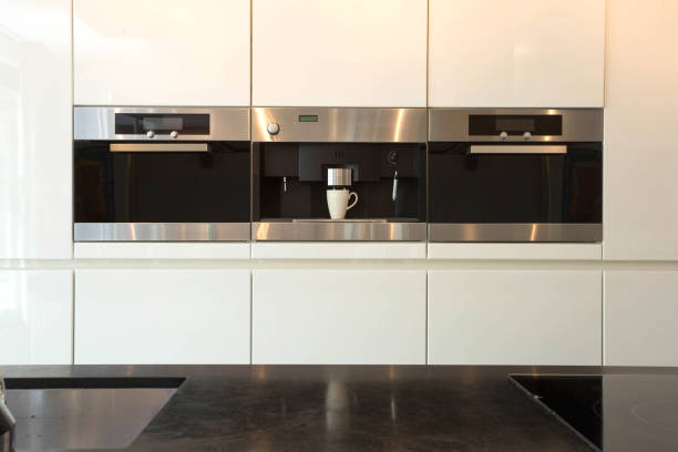 istock Elegant and modern white kitchen interior with oven and coffee machine close-up clean and luxury interior 1150045843