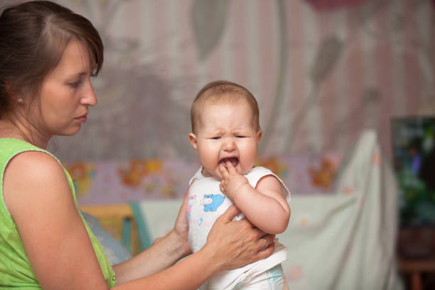 istock a young woman with a child is teething 1150045879