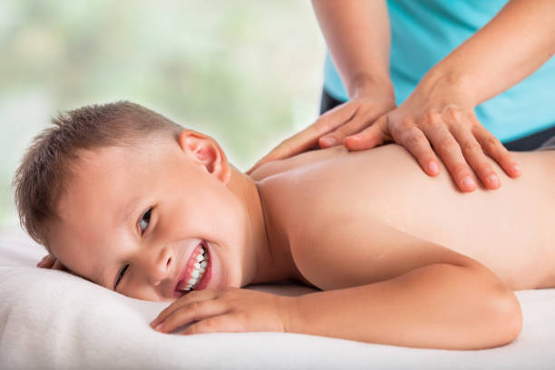 Masseur doing massage boy, massage boy love, he is happy and relaxed