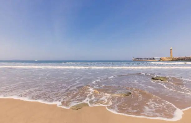 Photo of Whitby beach and pier.