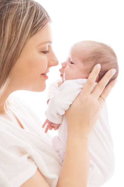 Mother with Newborn Baby, Mom looking to New Born Kid Face Mother with Newborn Baby, Mom looking to New Born Kid Face, Two Weeks Old Child on White babyhood photos stock pictures, royalty-free photos & images