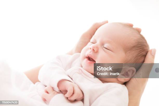 Newborn Baby Sleep On Mother Hands New Born Girl Smiling And Sleeping Stock Photo - Download Image Now