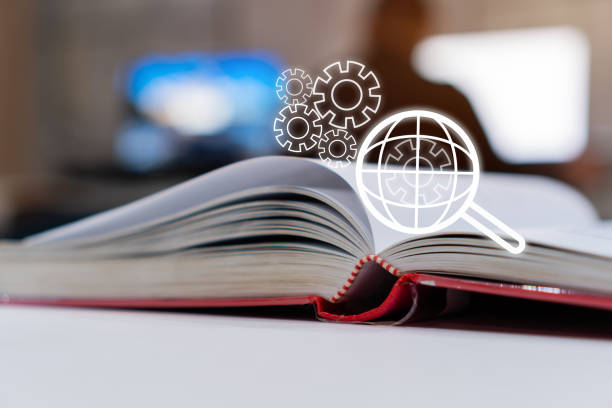 istock SEO search engine or E-book online learning for study concept with Magnifying glass with gear engine on global world checklist on open textbook background. Ideas for analysis over information and data 1150049261