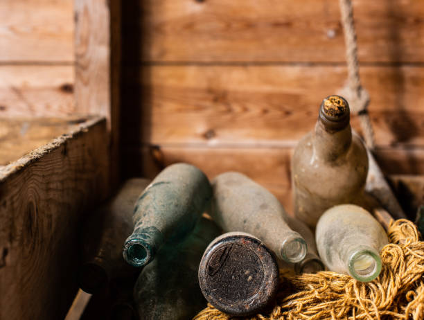 istock Vintage and dusty flasks stored in wooden crates. 1150051373