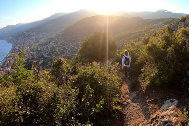 istock Female hiker walks down trail at sunset 1150051708