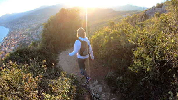 istock Female hiker walks down trail at sunset 1150051880