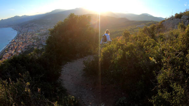 istock Female hiker walks down trail at sunset 1150051910