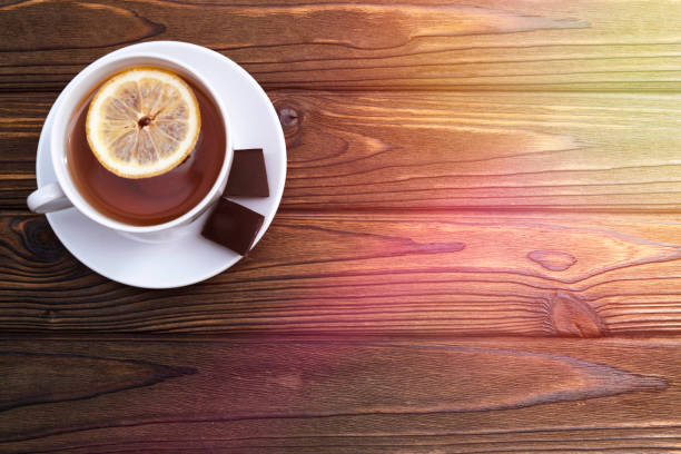 istock Cup of tea with lemon, two pieces of chocolate 1150055842