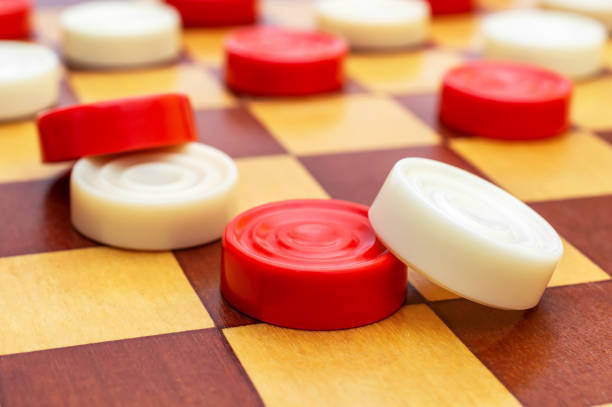 istock Checkers on wooden checkerboard. Close up. 1150056964