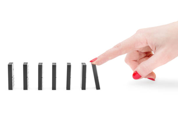 istock Woman's hand making domino effect on white background. 1150057219